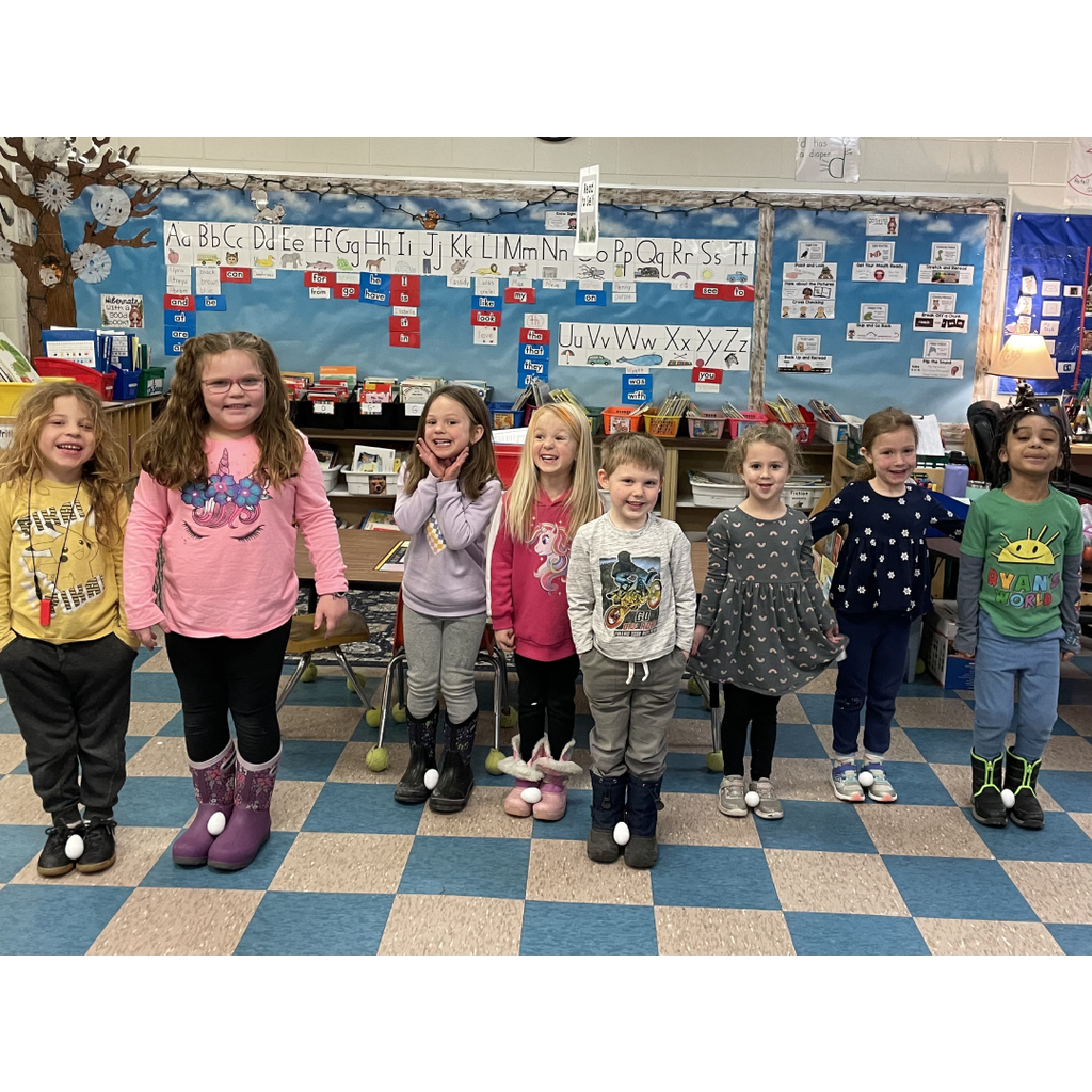 Kindergartners carrying eggs like emperor penguins on a cold day