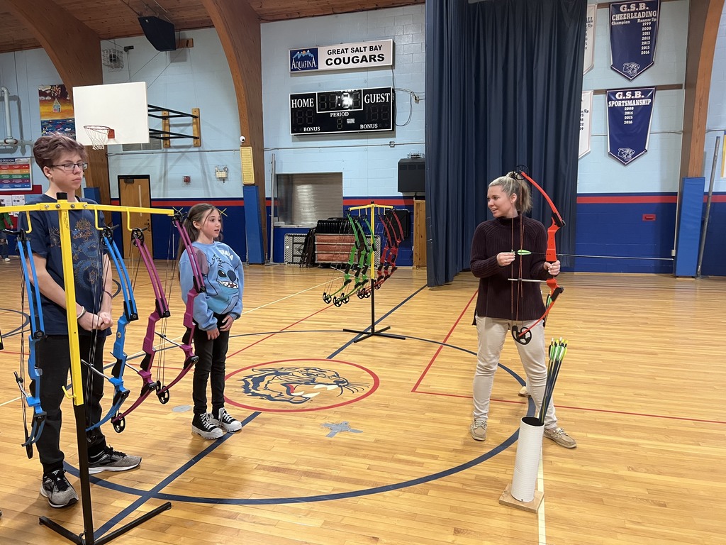 6th graders teaching the teachers archery