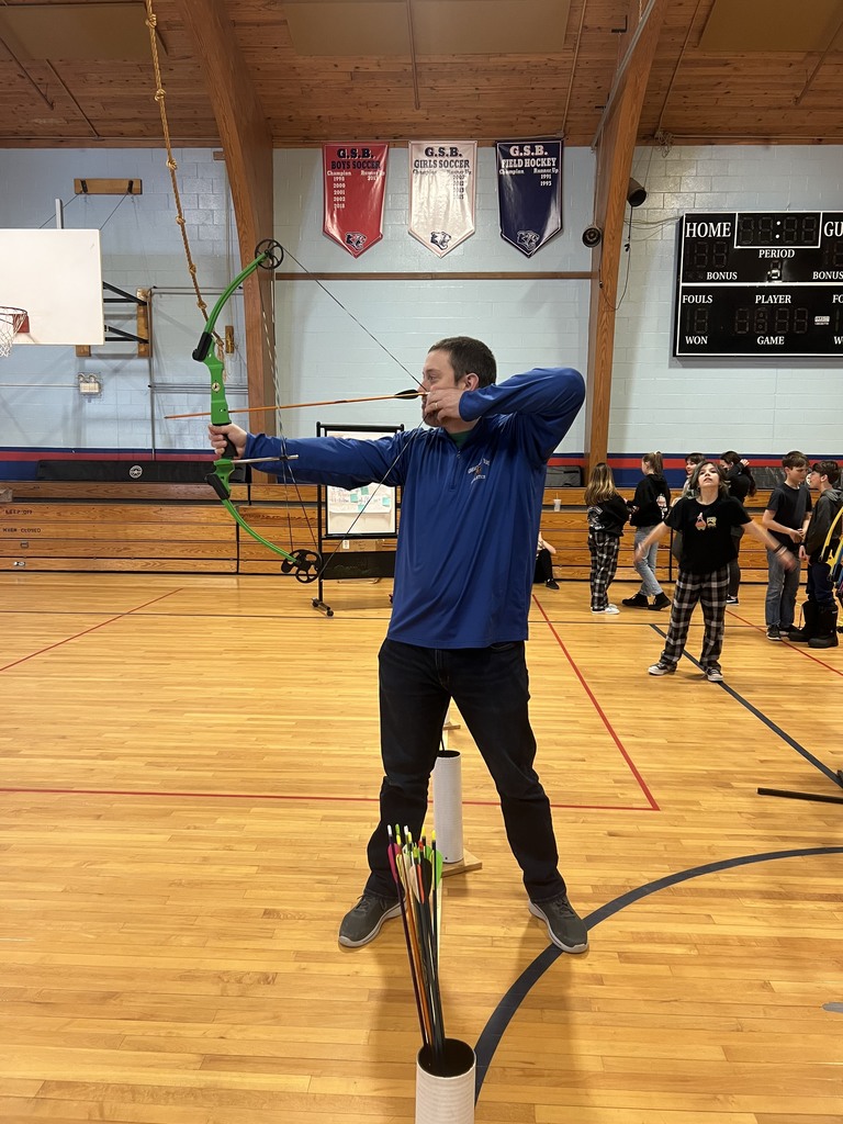 6th graders teaching the teachers archery