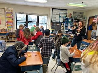 Jill Davis teaching a 4th grade class some sewing skills in guidance!
