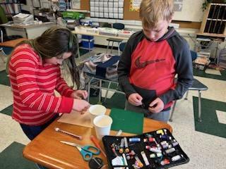 Jill Davis teaching a 4th grade class some sewing skills in guidance!