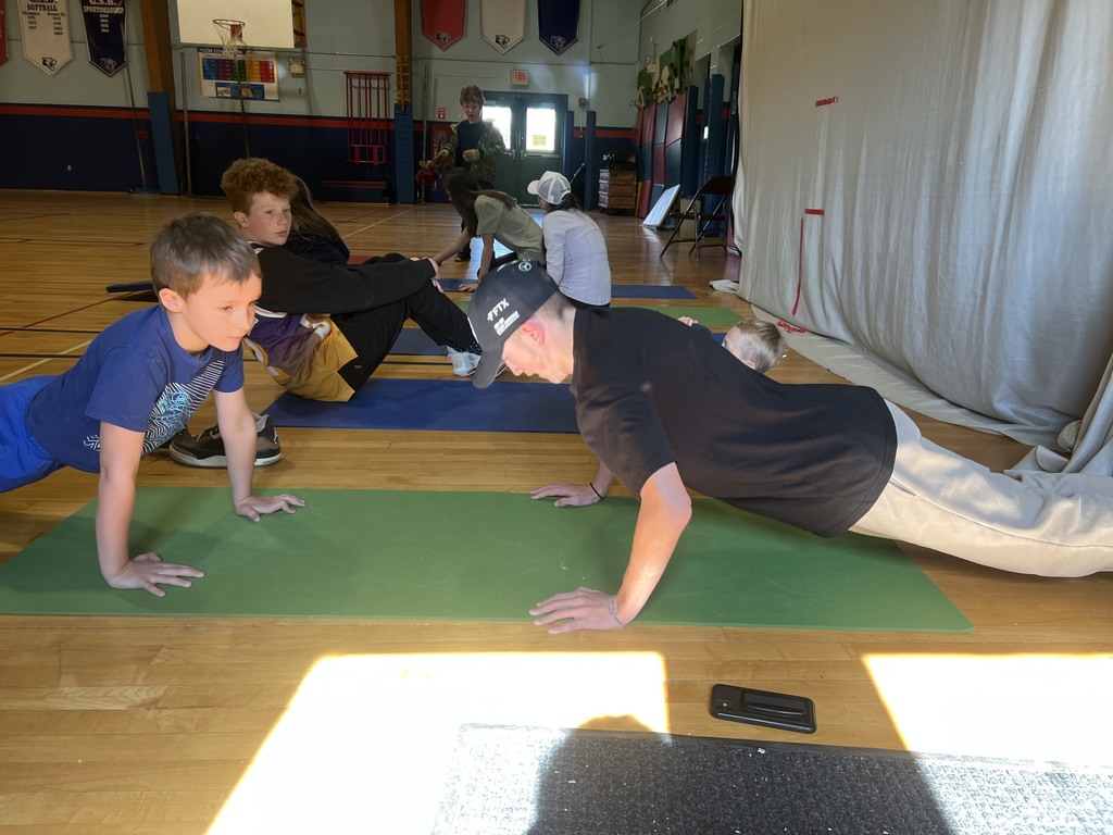 8th and 1st graders working together in PE
